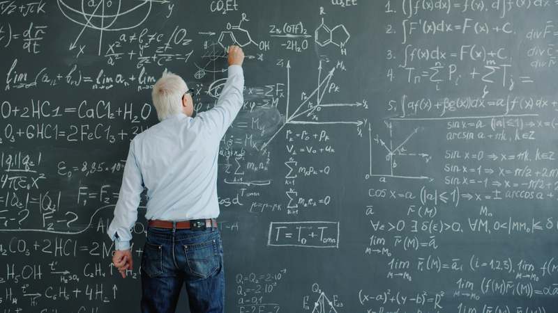 Diverse group of LSAT tutors reviewing logical reasoning questions at a desk